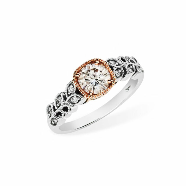 This gorgeous ornate Giana Rose Gold Engagement Ring is one of a kind. The centre stone is a 0,80ct Round Moissanite set in a Squared Rose Gold Setting. Eleven 1.00mm Round small accent moissanite are set on either side in the 9ct white gold band. A Bellissima Custom Engagement Ring from Jose Jewellers in Benoni, South Africa.